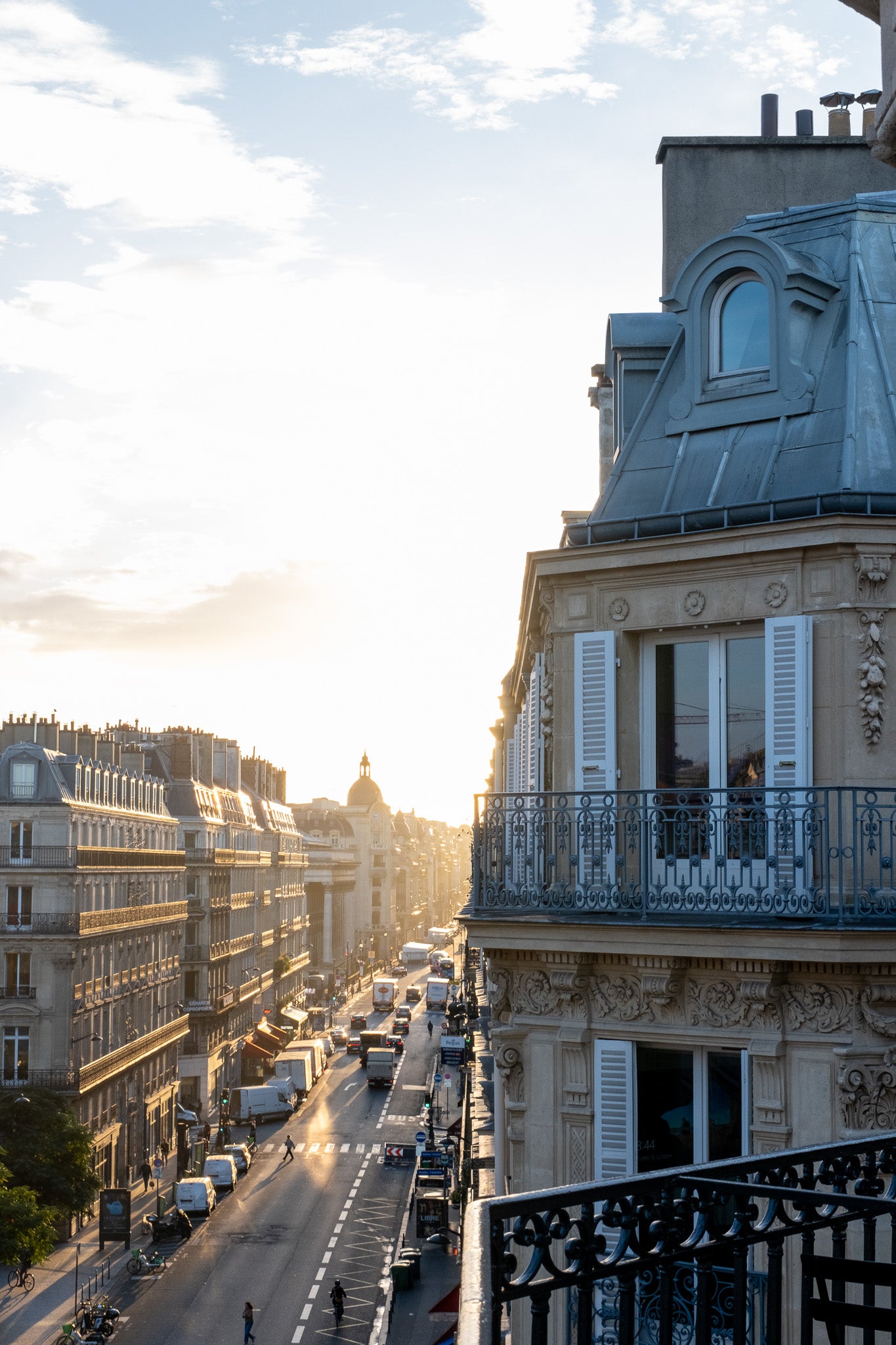 A photograph depicting a sunrise view from the top of a building in Paris.
